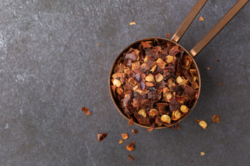 Crushed Red Pepper Flakes Spilled from a Teaspoon