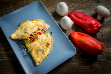 Omelette with bacon and vegetables. Meal, vegetable.