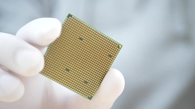 Hand of computer engineer brings computer cpu processor. Change components into socket processor for maintenance PC. Technology and development concept
