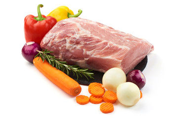Raw pork neck boneless with vegetables, isolated on white background. Close-up