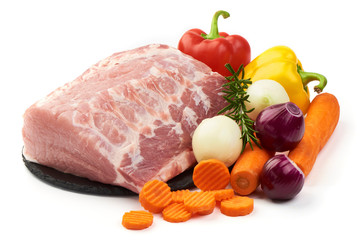 Raw pork neck boneless with vegetables, isolated on white background. Close-up