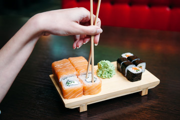 woman wrong eating sushi with chopsticks