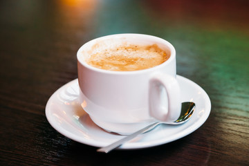 cup of coffee on wooden table