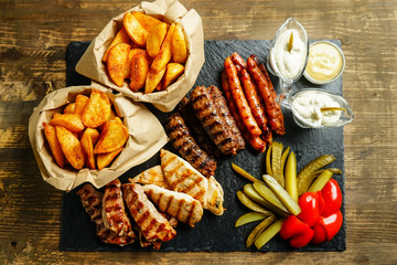 Potatoes, fried meat, littles and pickles on plate. Traditional romanian food.