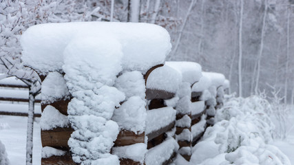 Old wooden snow covered wooden board on a cloudy winter day
