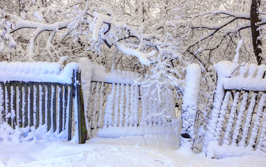 Old wooden snow covered wooden board on a cloudy winter day