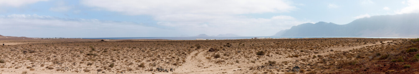 Fototapeta na wymiar Island desert with dirt road