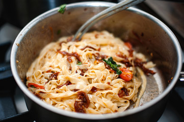 Cooking tomato sauce with pasta by chef