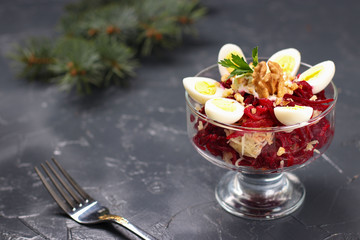 Beetroot and potato salad with quail eggs on a dark background