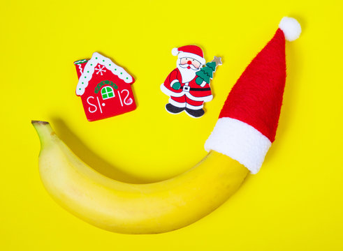 Christmas Banana In Santa's Cap On A Yellow Background