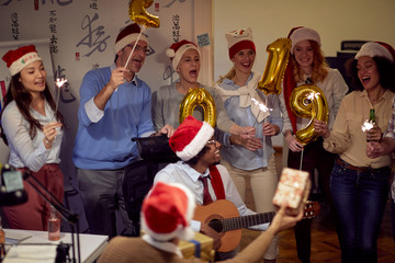 Successful business group people in Santa hat at Xmas party.