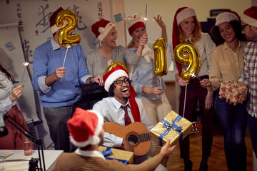 Successful business group people in Santa hat at Xmas party.