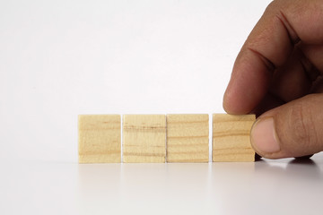 Close up man hand arranging wood block