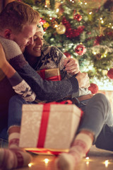 Gift surprise for Christmas- couple in love at Christmas night .