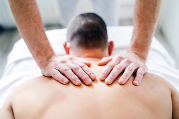 Young Man having massage In The Spa