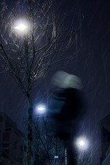 One person walking in city winter night