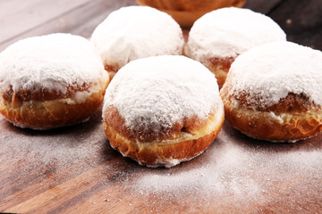 German donuts with jam and icing sugar. Carnival powdered sugar raised donuts