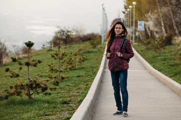 young woman tourist smiling walking on the road in the Park