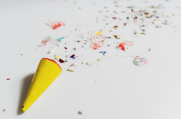 Exploding party popper on white background