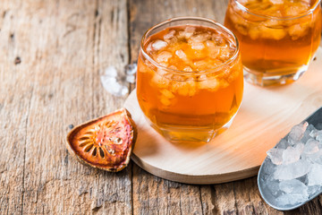 Bael juice ice tea on wooden table , healthy drink