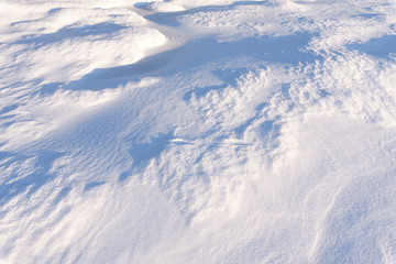 Snowdrift, wind sculpted patterns on snow surface.