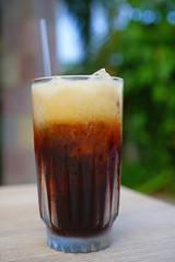 Glass of cold iced coffee with a straw