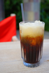 Glass of cold iced coffee with a straw