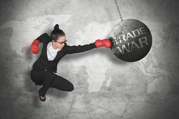Female entrepreneur punching trade war text