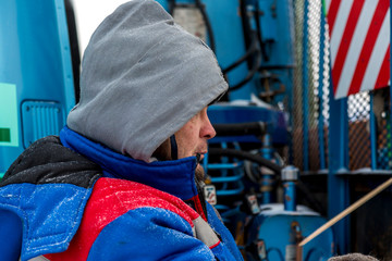 The driver of the hydraulic manipulator in the workplace