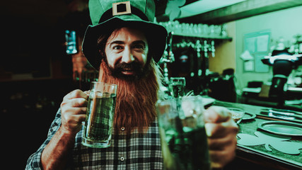 Guy In The Leprechaun Cap Is Drinking A Beer.