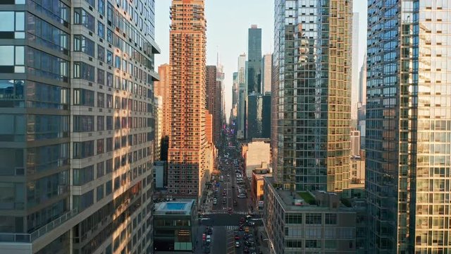 Aerial drone footage of New York skyline along 42nd street canyon, with upward camera motion