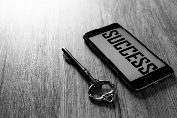 Key to success, smart phone with key of success.