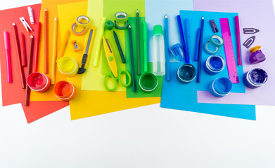 School accessories are laid out in the form of a rainbow. Copy space. white background. banner