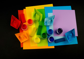 School accessories are laid out in the form of a rainbow. Black background.