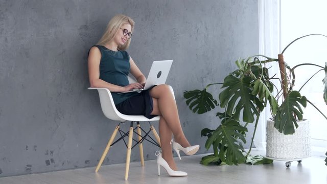 Woman working on laptop at office