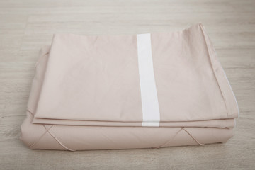 Bedclothes on the bed made with pillows.