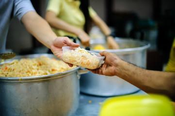The hands of beggars receive donated food as a share in society : the concept of hunger