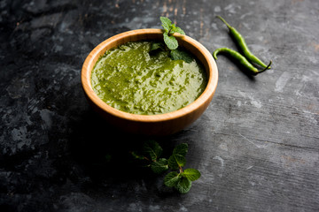 Healthy Green Mint Chutney Made with Coriander, pudina And Spices. isolated moody background. selective focus