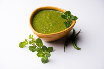 Healthy Green Mint Chutney Made with Coriander, pudina And Spices. isolated moody background. selective focus