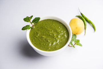 Healthy Green Mint Chutney Made with Coriander, pudina And Spices. isolated moody background. selective focus