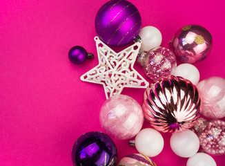 Gentle pink and purple baubles on a pink background. Christmas mood. Copy space
