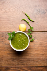 Healthy Green Mint Chutney Made with Coriander, pudina And Spices. isolated moody background. selective focus