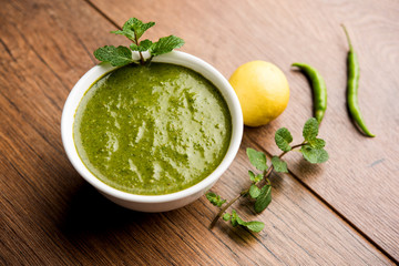 Healthy Green Mint Chutney Made with Coriander, pudina And Spices. isolated moody background. selective focus