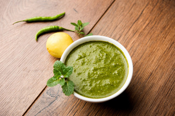 Healthy Green Mint Chutney Made with Coriander, pudina And Spices. isolated moody background. selective focus
