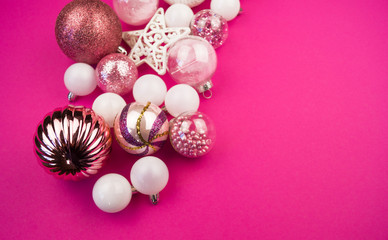 Gentle pink and white baubles on a pink background. Christmas mood. Copy space