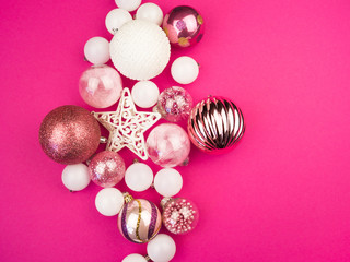 Gentle pink and white baubles on a pink background. Christmas mood. Copy space
