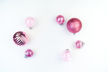 Gentle pink baubles on a white background. Christmas mood. Copy space