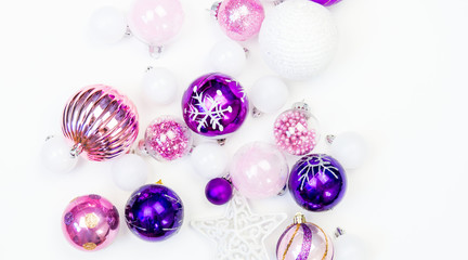 Gentle pink and purple baubles on a white background. Christmas mood. Copy space