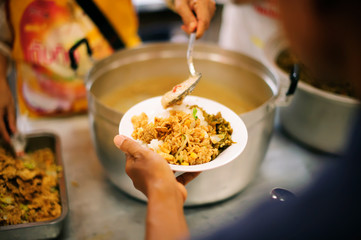 Poor people receiving food from donations : the concept of social sharing