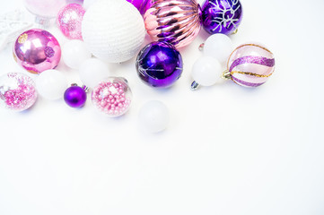 Gentle pink and purple baubles on a white background. Christmas mood. Copy space